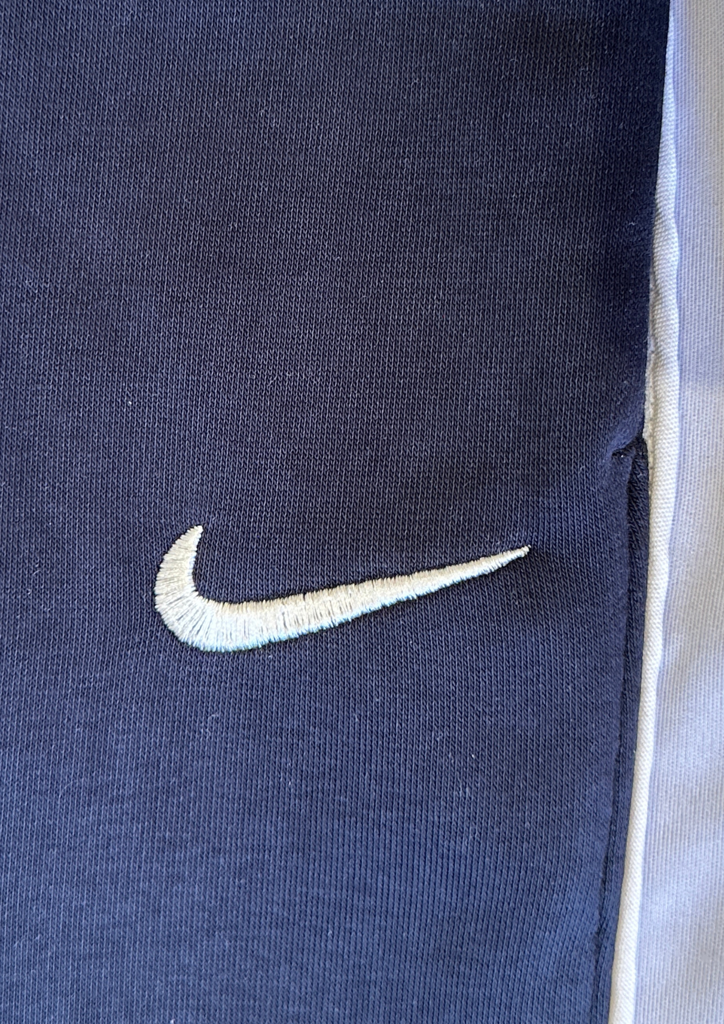 "Close-up of embroidered Nike logo – Nokkta Nike Wide-Leg Oversized Sweatpants"